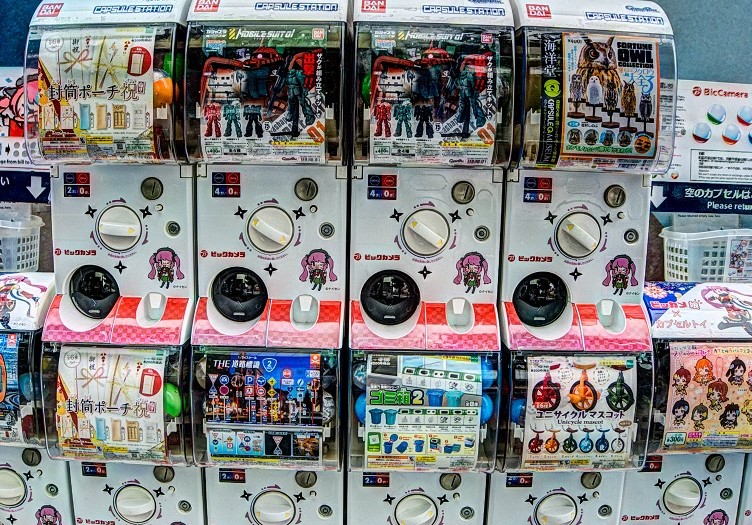 Japanese Gachapon capsule toy vending machines displaying collectible toys and figures